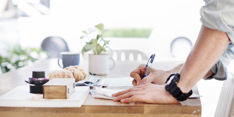 Man Writing Document Dinning Table Concept